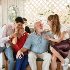 caregivers and family of dementia patient hug at Thanksgiving