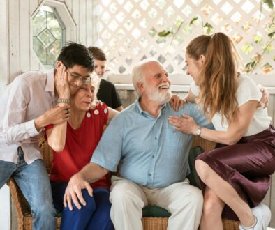 caregivers and family of dementia patient hug at Thanksgiving