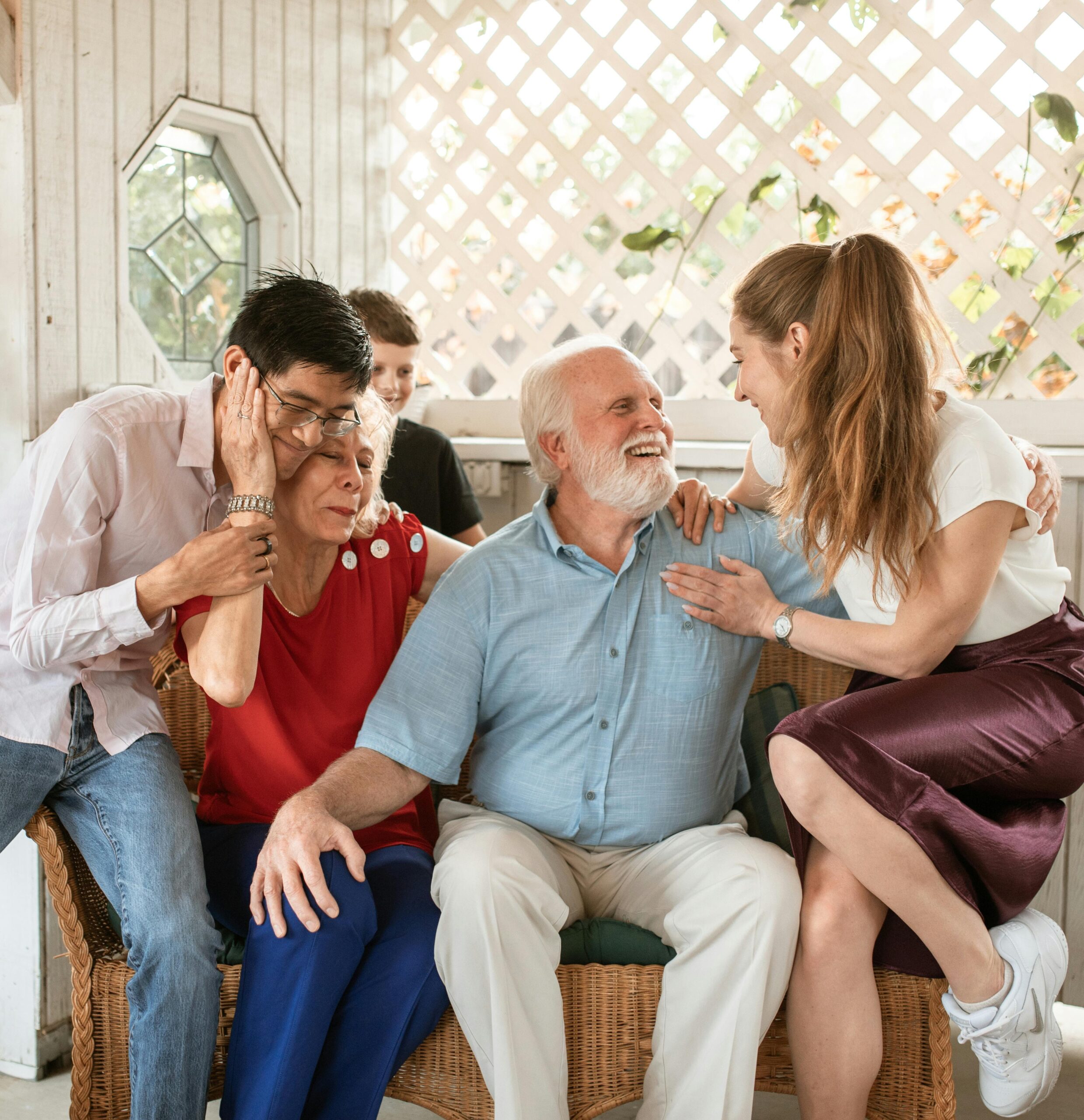 caregivers and family of dementia patient hug at Thanksgiving